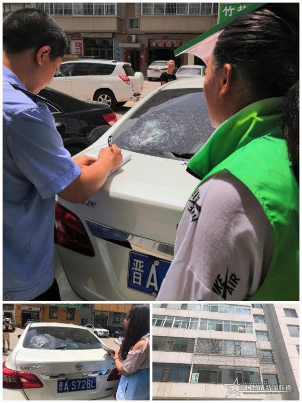麗景社區(qū)網(wǎng)格員張羊平和郝小清在排查中發(fā)現(xiàn)有樓層墜物砸壞了車窗，報警處理。王燕華攝.jpg
