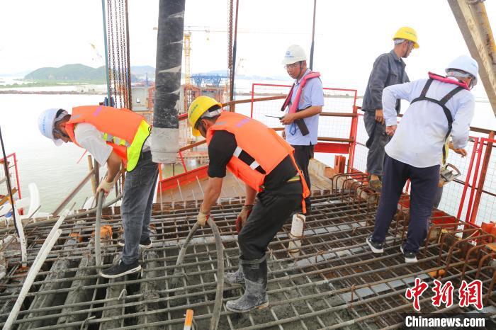 員工正在珠機(jī)城際鐵路金海大橋項(xiàng)目鶴洲側(cè)68號墩(左幅)澆筑1號塊混凝土情景。孟慶虎 攝